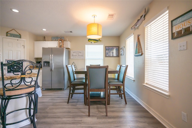 dining area featuring dark wood-type flooring