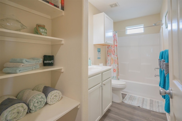 full bathroom featuring vanity, toilet, wood-type flooring, and shower / bathtub combination with curtain