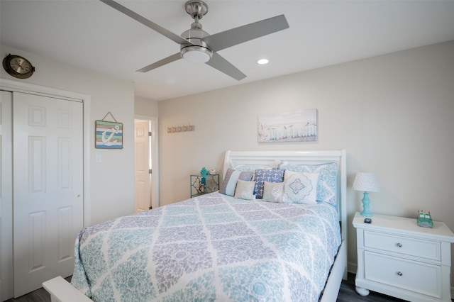 bedroom featuring dark hardwood / wood-style flooring, a closet, and ceiling fan