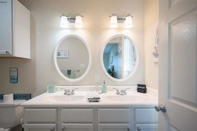 bathroom featuring vanity and toilet