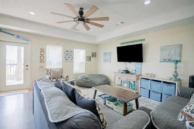 living room with ceiling fan and hardwood / wood-style floors