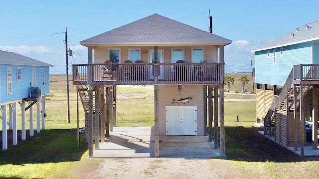 12919 Coronado Dr, Freeport, TX 77541 - view of front facade featuring stairway, central air condition unit, a front yard, and a shingled roof