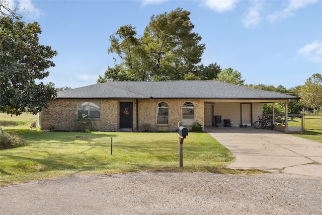 single story home featuring a carport and a front lawn