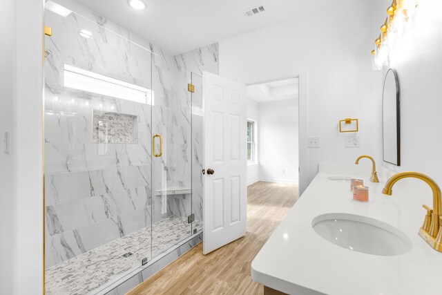 bathroom featuring vanity, a shower with shower door, and wood-type flooring