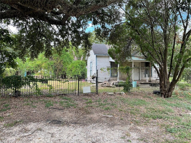 view of property hidden behind natural elements featuring a porch