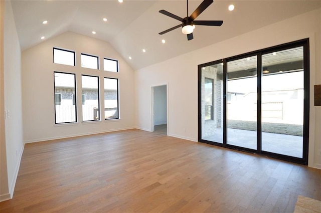 unfurnished room with high vaulted ceiling, ceiling fan, and light hardwood / wood-style flooring