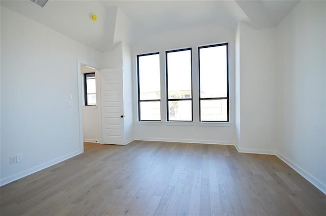 unfurnished room featuring hardwood / wood-style flooring