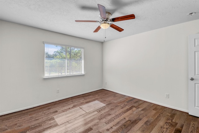 spare room with ceiling fan, wood-type flooring, and a textured ceiling