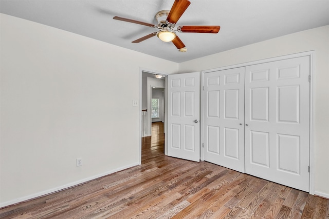 unfurnished bedroom featuring light hardwood / wood-style flooring, a closet, and ceiling fan