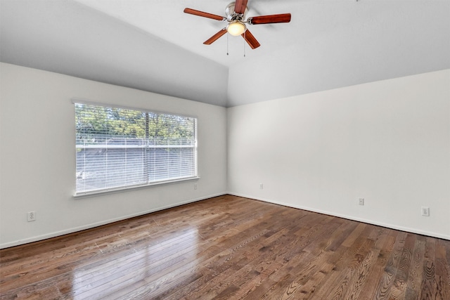 empty room with lofted ceiling, hardwood / wood-style floors, and ceiling fan