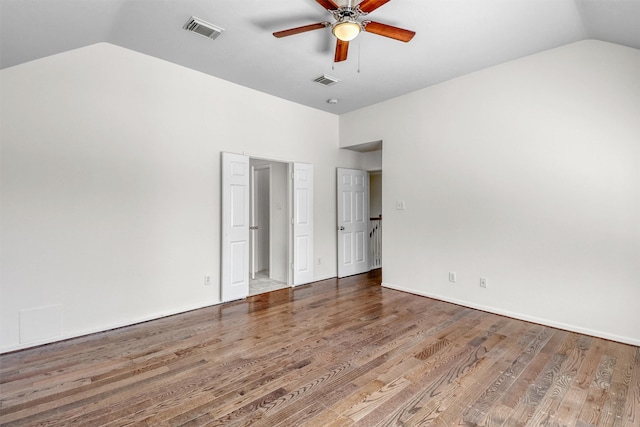 spare room featuring hardwood / wood-style flooring, lofted ceiling, and ceiling fan