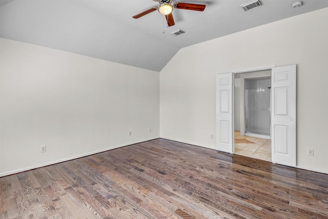 spare room featuring vaulted ceiling, ceiling fan, and light hardwood / wood-style floors