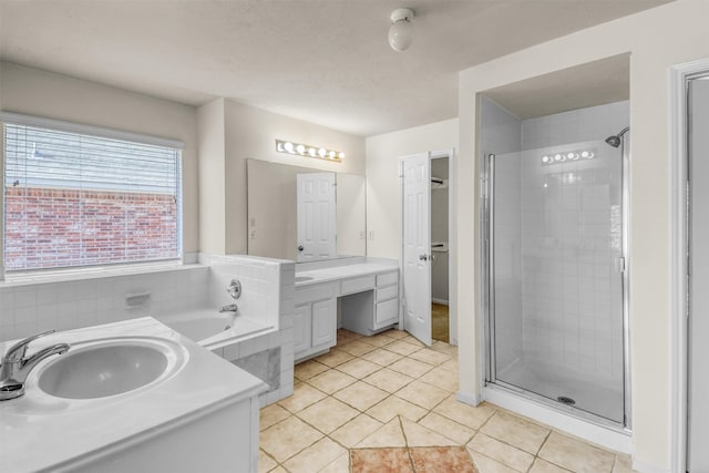 bathroom with tile patterned floors, independent shower and bath, and vanity