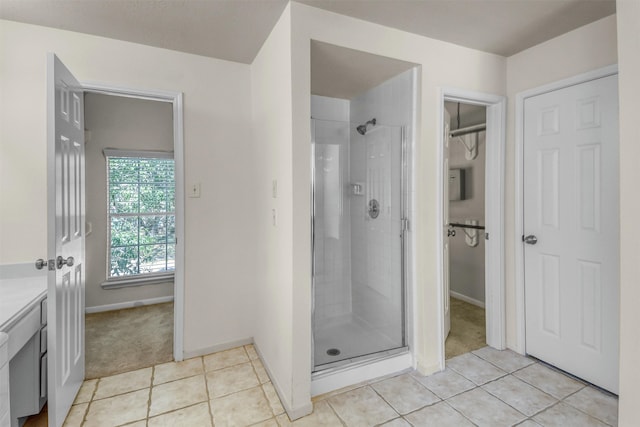 bathroom with vanity, an enclosed shower, and tile patterned floors