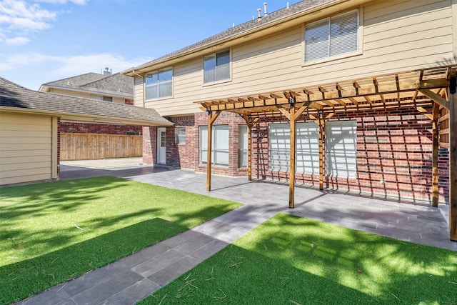 back of property featuring a lawn and a patio