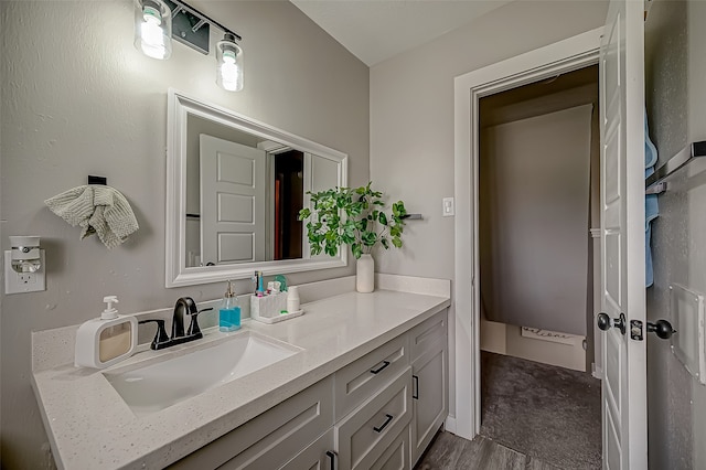 bathroom with vanity and hardwood / wood-style flooring