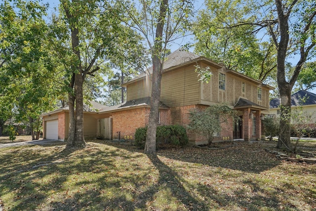 view of front of property with a front yard and a garage