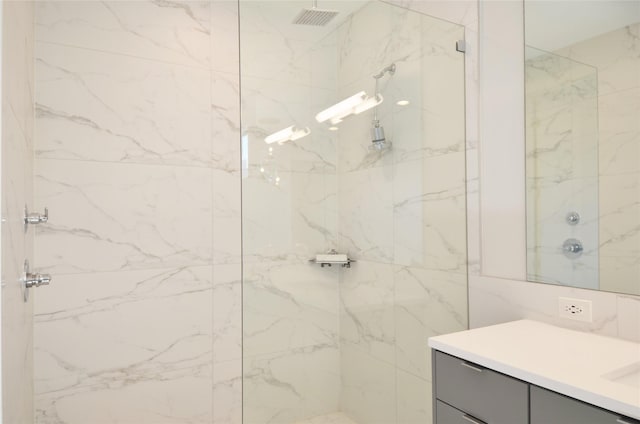 bathroom featuring vanity and a tile shower