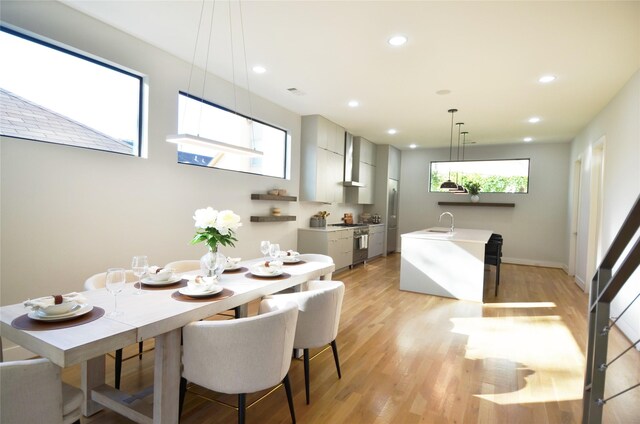 dining room featuring light hardwood / wood-style flooring and sink