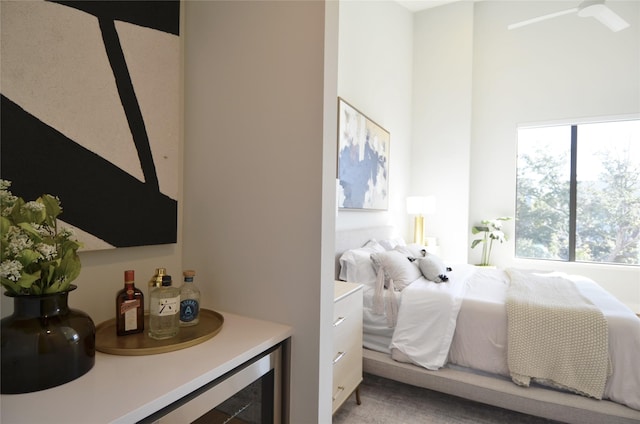 bedroom with bar area, multiple windows, and ceiling fan