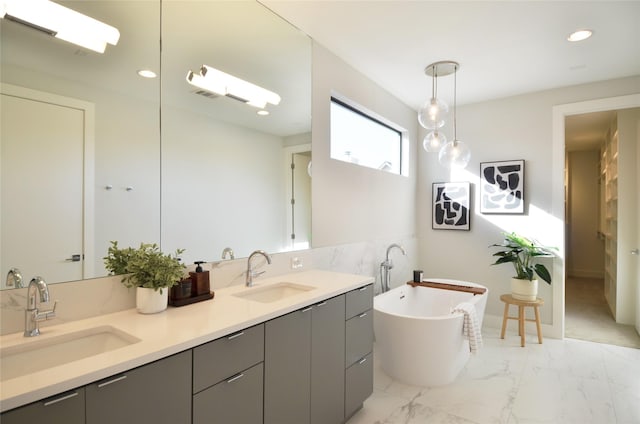 bathroom with vanity, a tub to relax in, and tile walls