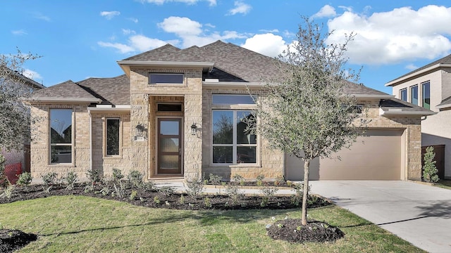 view of front of house featuring a front lawn and a garage