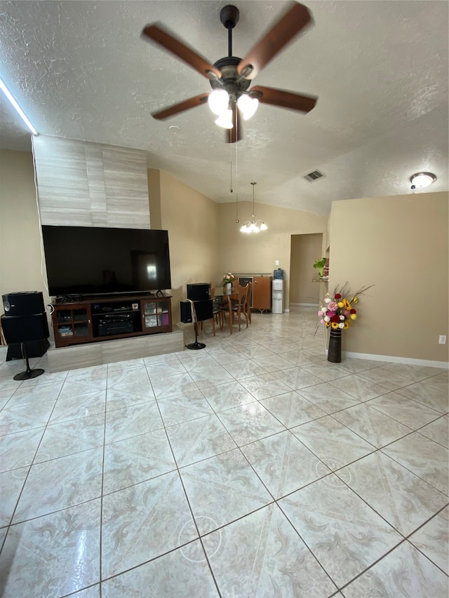 unfurnished living room featuring lofted ceiling, a textured ceiling, and ceiling fan