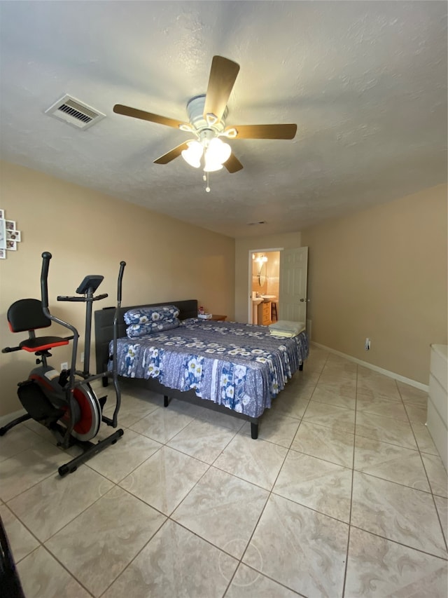 bedroom with ceiling fan, a textured ceiling, and light tile patterned flooring