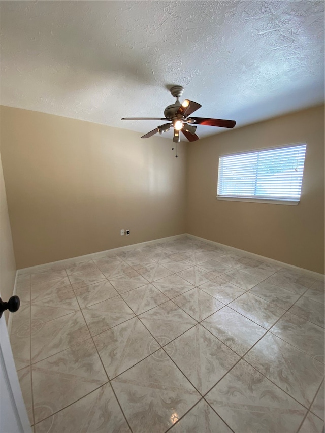 unfurnished room featuring a textured ceiling and ceiling fan