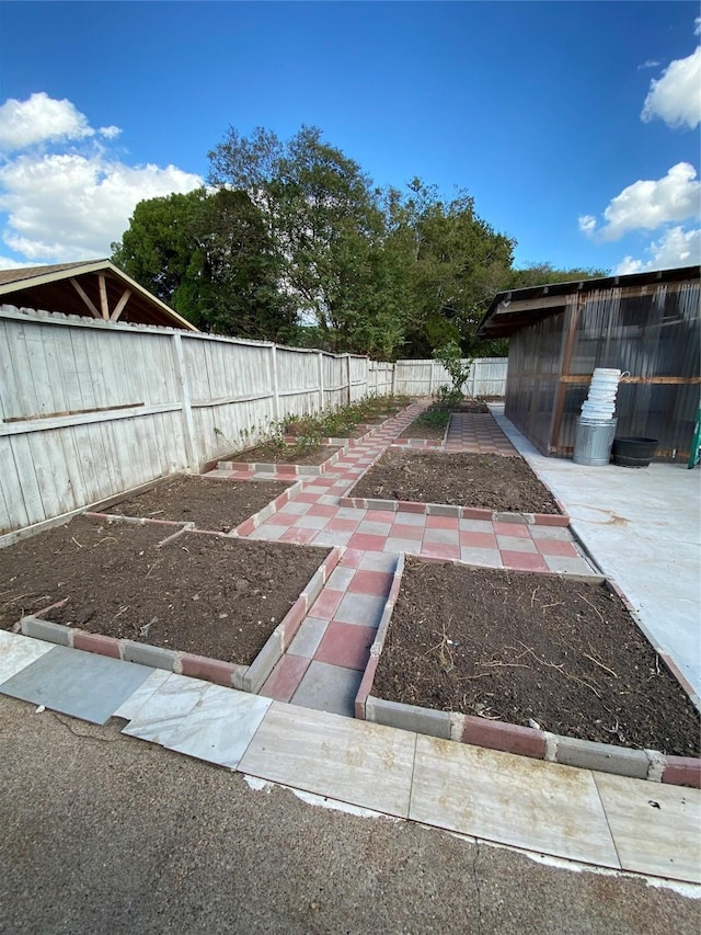15810 Amapola Dr, Houston, TX 77083 - view of yard featuring a fenced backyard and a garden