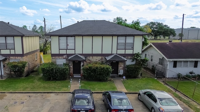 view of front of house featuring a front yard and central AC unit