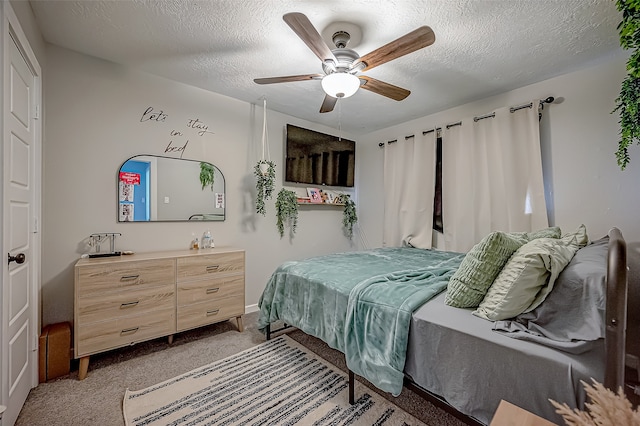 carpeted bedroom with ceiling fan and a textured ceiling