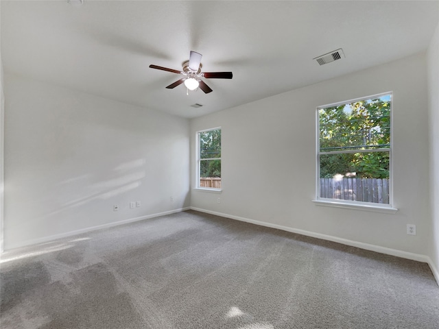 unfurnished room featuring ceiling fan and carpet floors