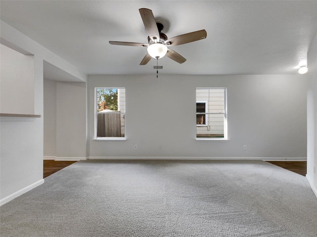 carpeted spare room with ceiling fan