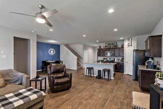 living room with dark hardwood / wood-style floors and ceiling fan