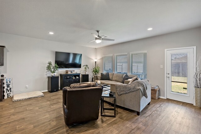 living room with wood-type flooring and ceiling fan