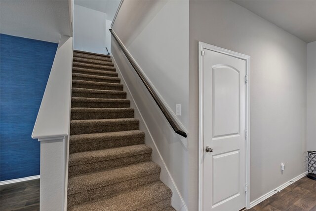 stairway featuring hardwood / wood-style flooring