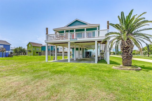 rear view of house with a yard and a carport