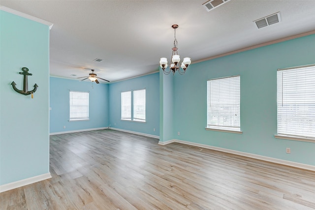 empty room featuring ornamental molding, ceiling fan with notable chandelier, and light wood-type flooring