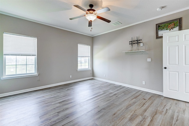 spare room with crown molding, light hardwood / wood-style flooring, and ceiling fan