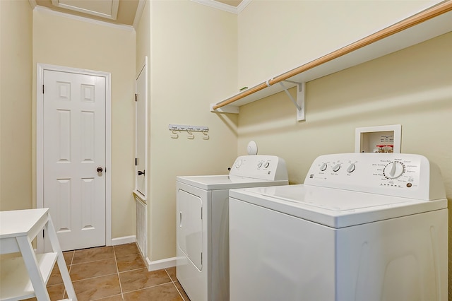 laundry room with ornamental molding, light tile patterned flooring, and separate washer and dryer