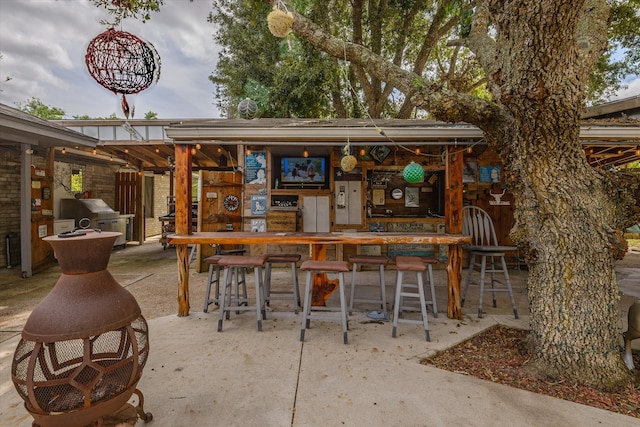 view of patio / terrace with an outdoor bar and a grill