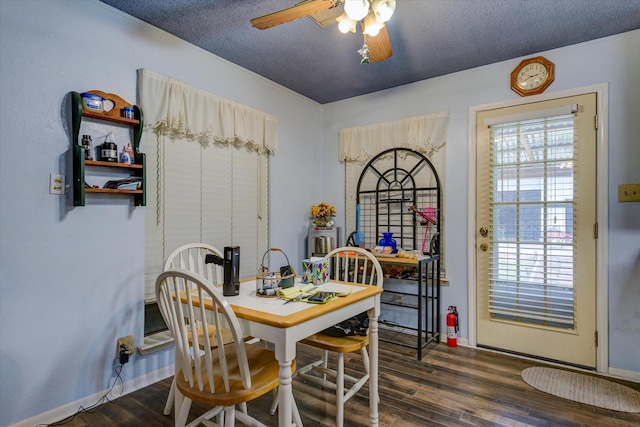 dining space featuring a textured ceiling, ceiling fan, and wood finished floors