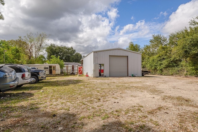 exterior space featuring an outbuilding and a detached garage