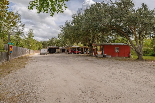 exterior space with fence, a carport, and driveway