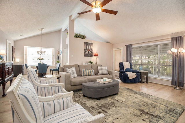 living room featuring beam ceiling, a textured ceiling, light hardwood / wood-style flooring, and ceiling fan with notable chandelier