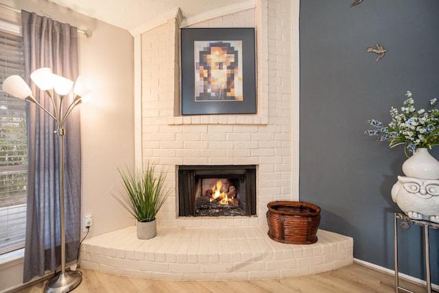 room details with crown molding, wood-type flooring, and a fireplace