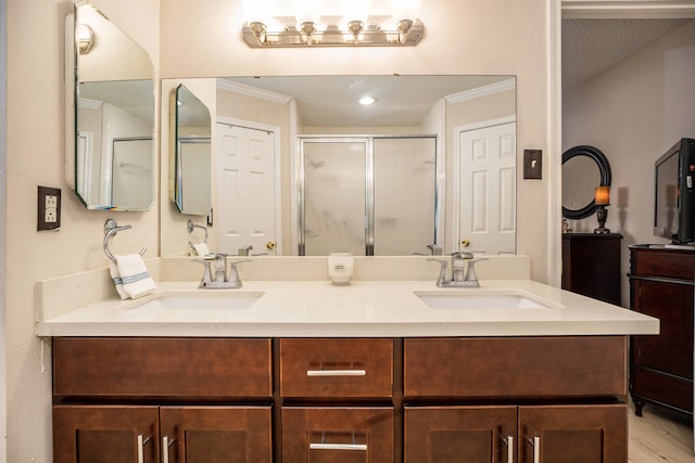 bathroom featuring vanity, crown molding, walk in shower, and hardwood / wood-style floors