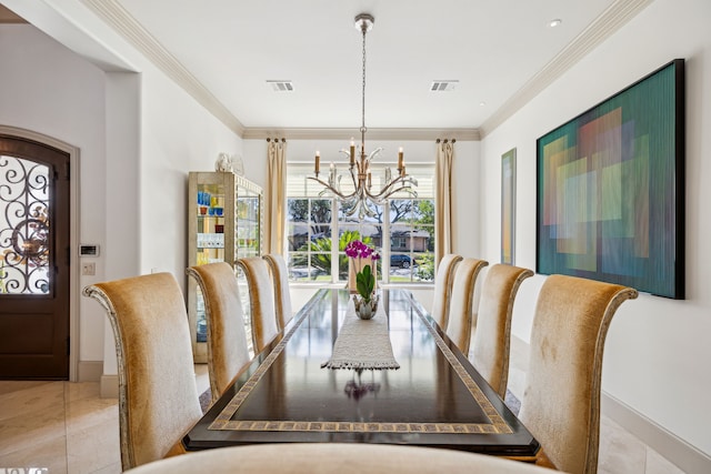 tiled dining room featuring ornamental molding and an inviting chandelier