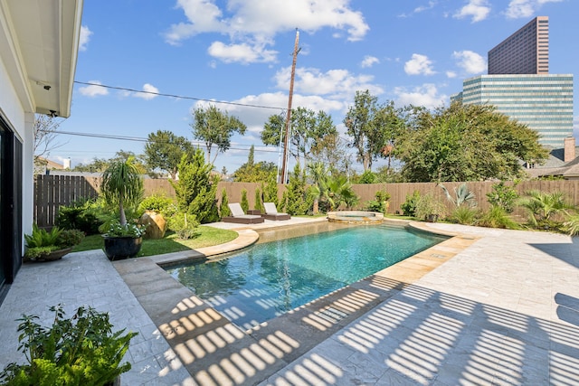 view of pool with an in ground hot tub and a patio